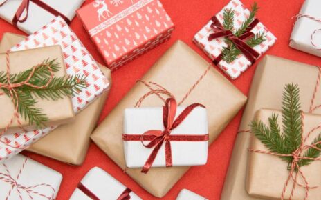 Colorful gift box with festive pattern and bow accessory on white background
