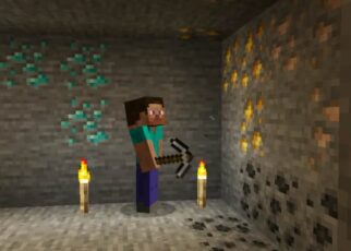 Minecraft player mining iron ore vein at Y=16 in deep cave with torches lit.
